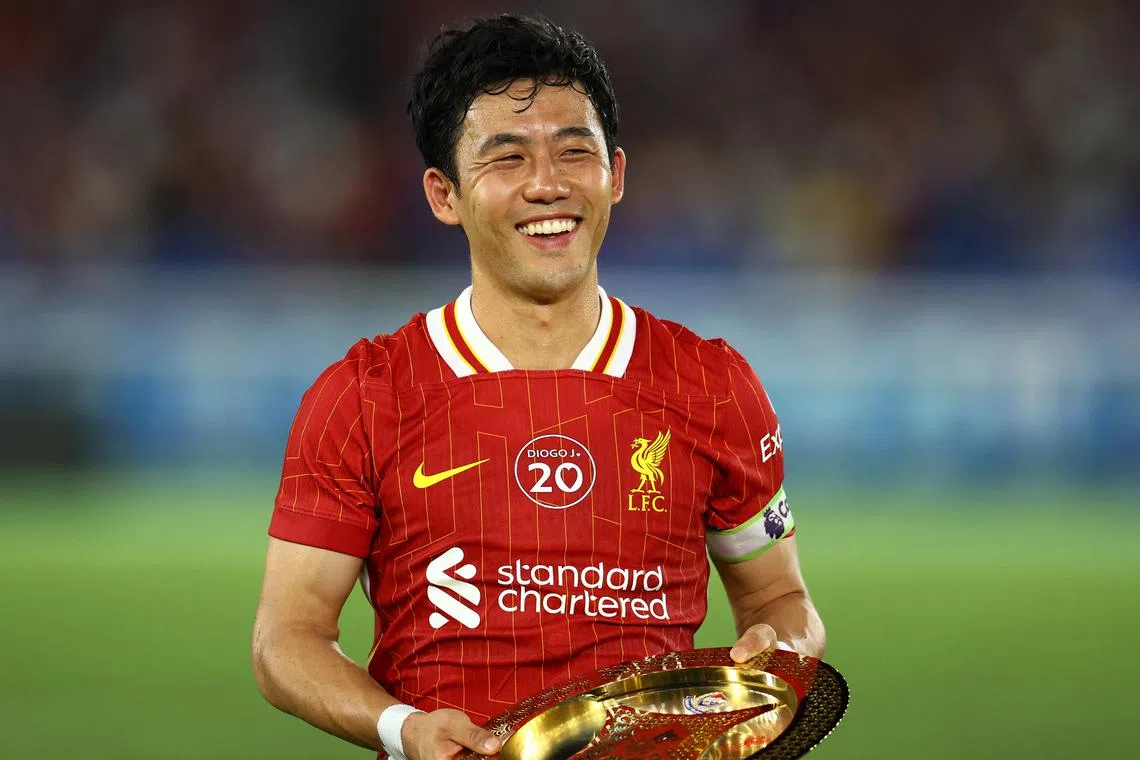 Soccer Football - Pre-Season Friendly - Yokohama F Marinos v Liverpool - Nissan Stadium, Yokohama, Japan - July 30, 2025 Liverpool's Wataru Endo is presented with an award after the match REUTERS/Issei Kato