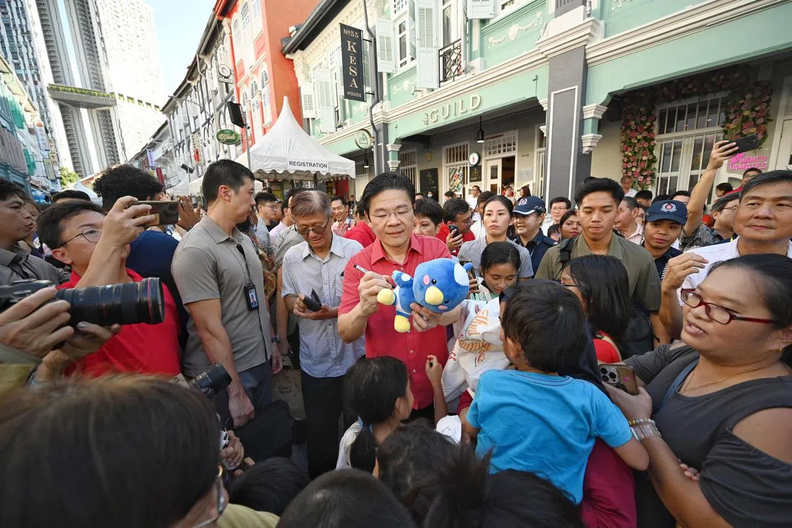 PM Lawrence Wong interacting with the crowd during the launch of Qixi Fest 2024 in Keong Saik Road on Aug 3.