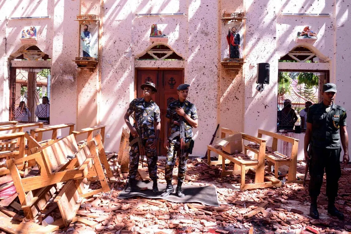 Sri Lankan soldiers inspect the St Sebastian’s Church at Katuwapitiya in Negombo on April 21, 2019, following a bomb blast during an Easter service.
