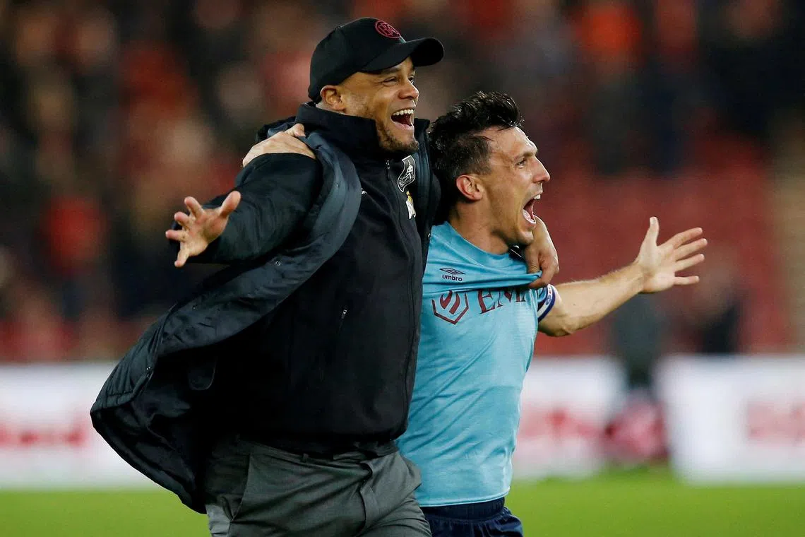 Burnley manager Vincent Kompany celebrates promotion to the Premier League with Jack Cork.    