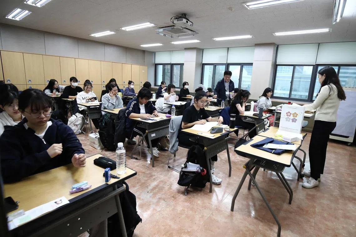 South Korean students wait to take the annual College Scholastic Ability Test, known locally as Suneung, at a school in Seoul.