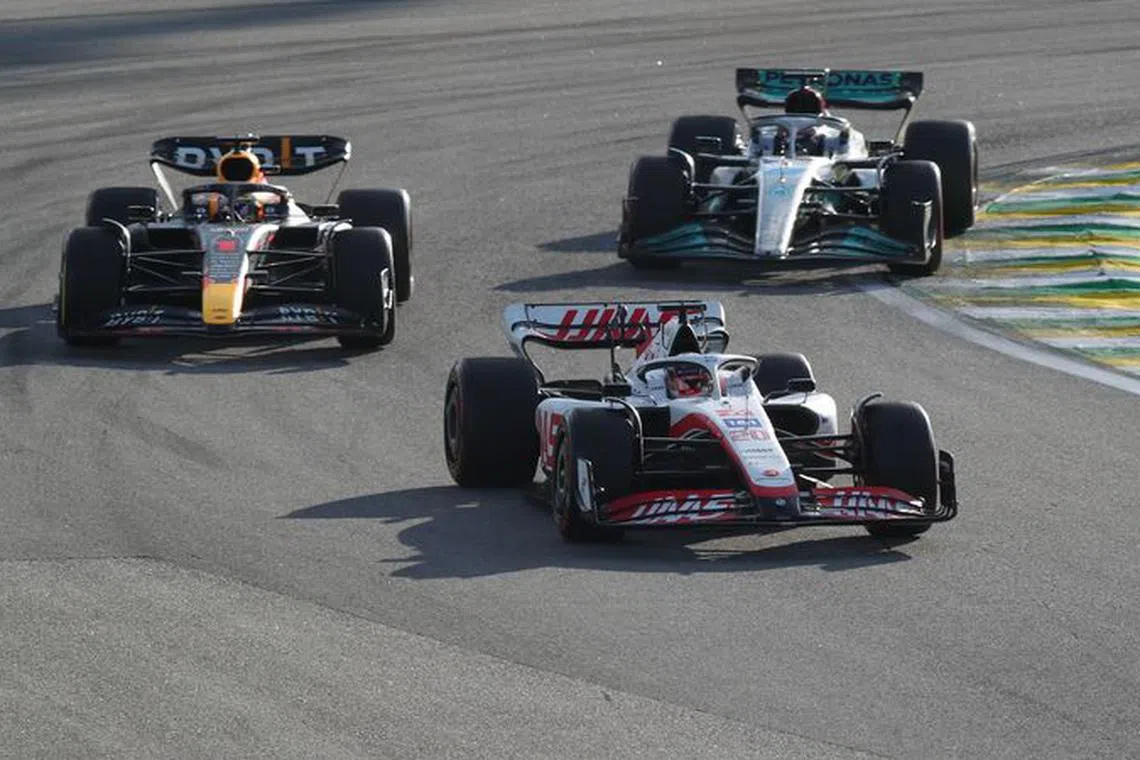 FILE PHOTO: Formula One F1 - Brazilian Grand Prix - Jose Carlos Pace Circuit, Sao Paulo, Brazil - November 12, 2022 Haas' Kevin Magnussen ahead of Red Bull's Max Verstappen and Mercedes' George Russell during sprint qualifying REUTERS/Amanda Perobelli/File Photo