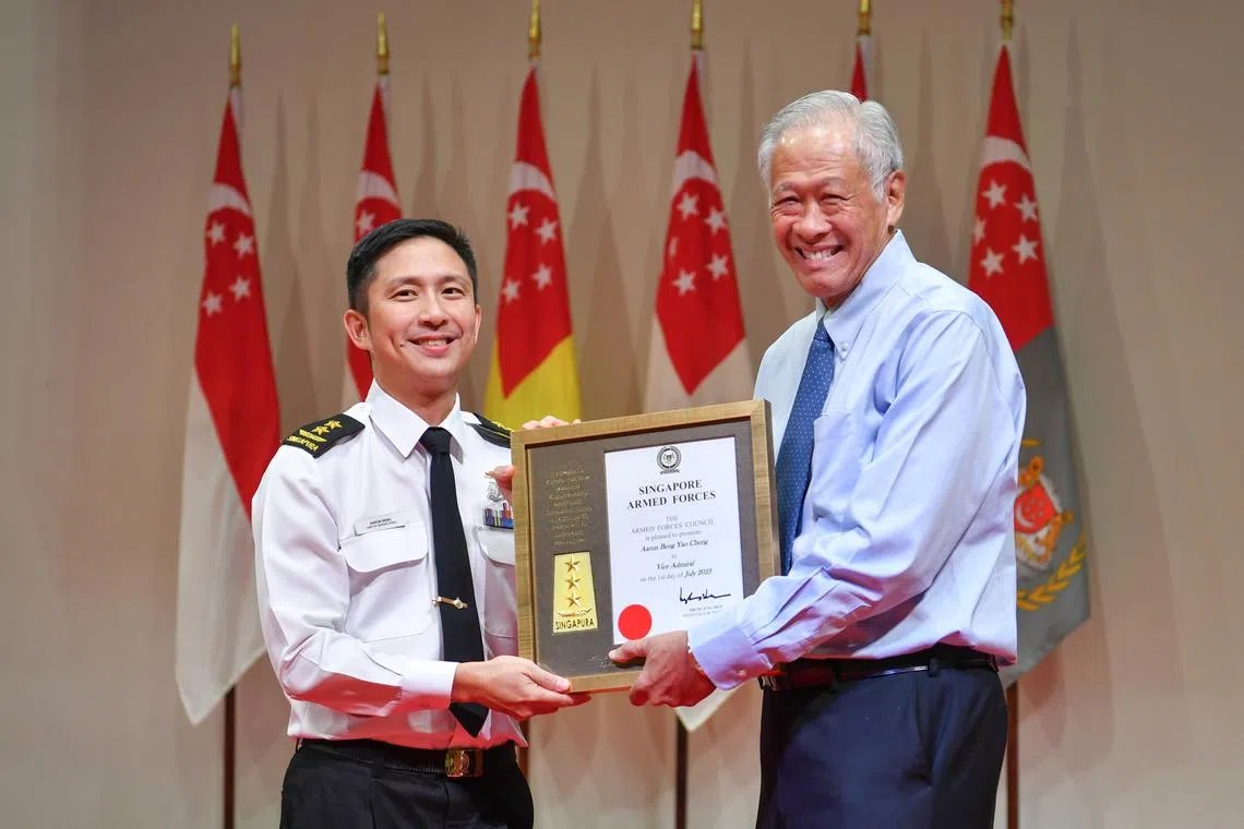 Minister for Defence Ng Eng Hen (right) presenting the promotion certificate to Chief of Defence Force Aaron Beng.