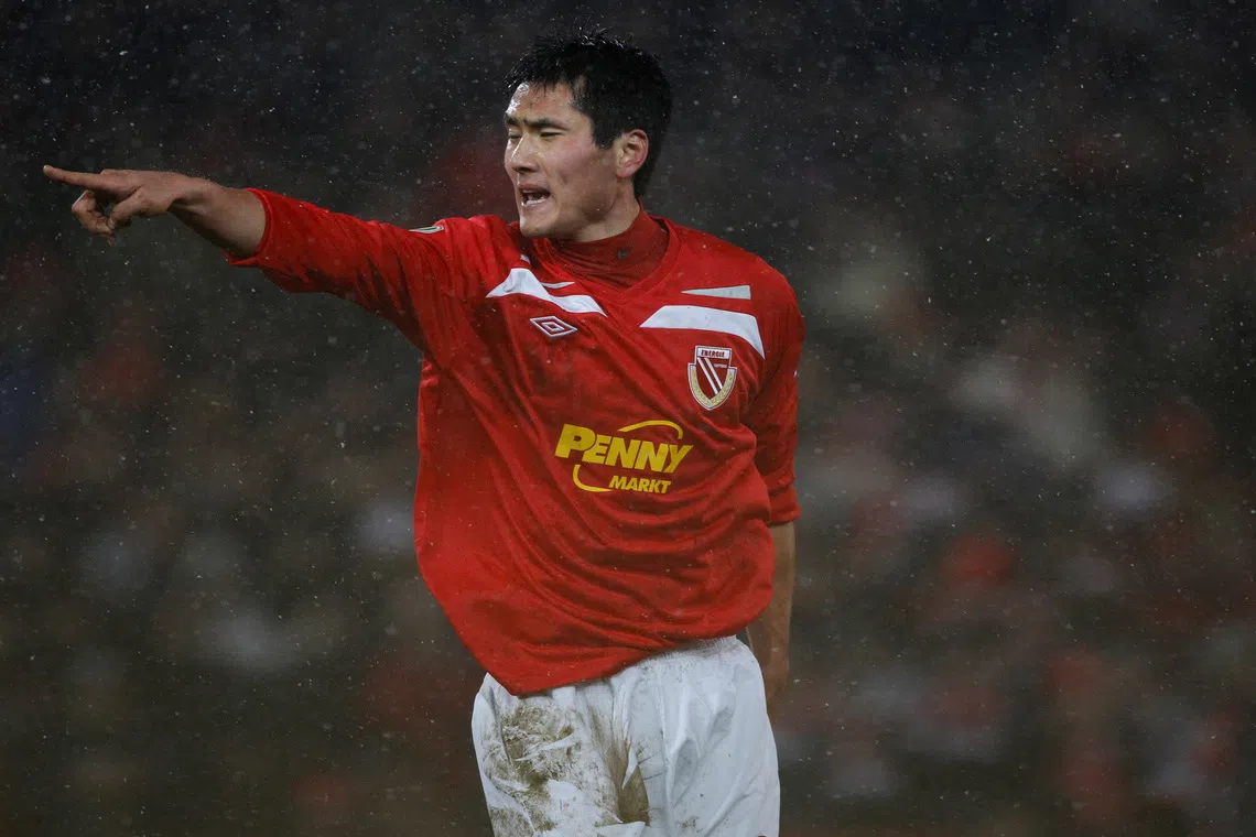 FILE PHOTO: Energie Cottbus' Jiayi Shao reacts after scoring at the German soccer cup (DFB-Pokal) quarter-final match against TSG 1899 Hoffenheim in Cottbus, January 26, 2011. Energie Cottbus won the match 1-0.   REUTERS/Tobias Schwarz/File Photo