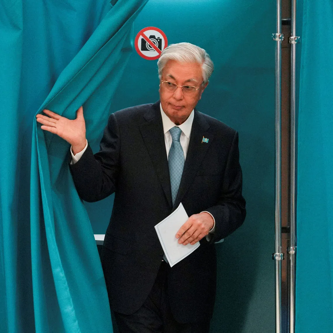 Kazakh President Kassym-Jomart Tokayev walks out of a voting booth at a polling station during a snap parliamentary election in Astana, Kazakhstan, August 23, 2026. REUTERS/Turar Kazangapov
