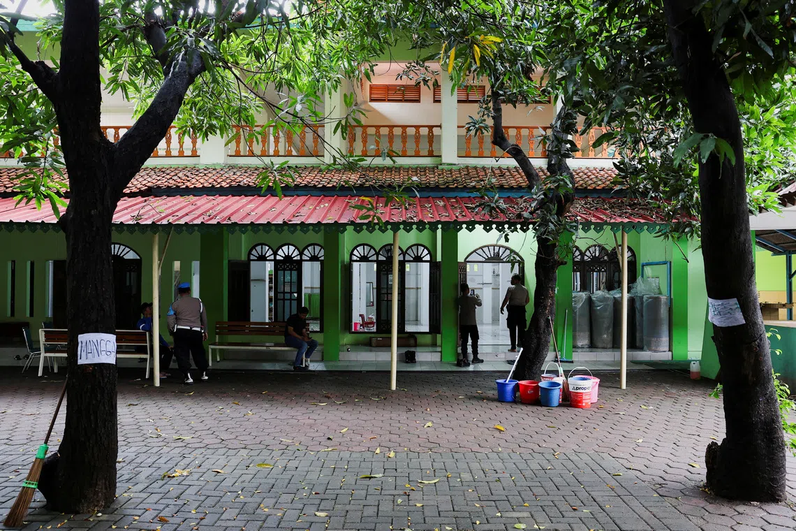 FILE PHOTO: Police officers guard outside a mosque where explosions occurred the previous day, at a school complex in Jakarta, Indonesia, November 8, 2025. REUTERS/Willy Kurniawan/File Photo