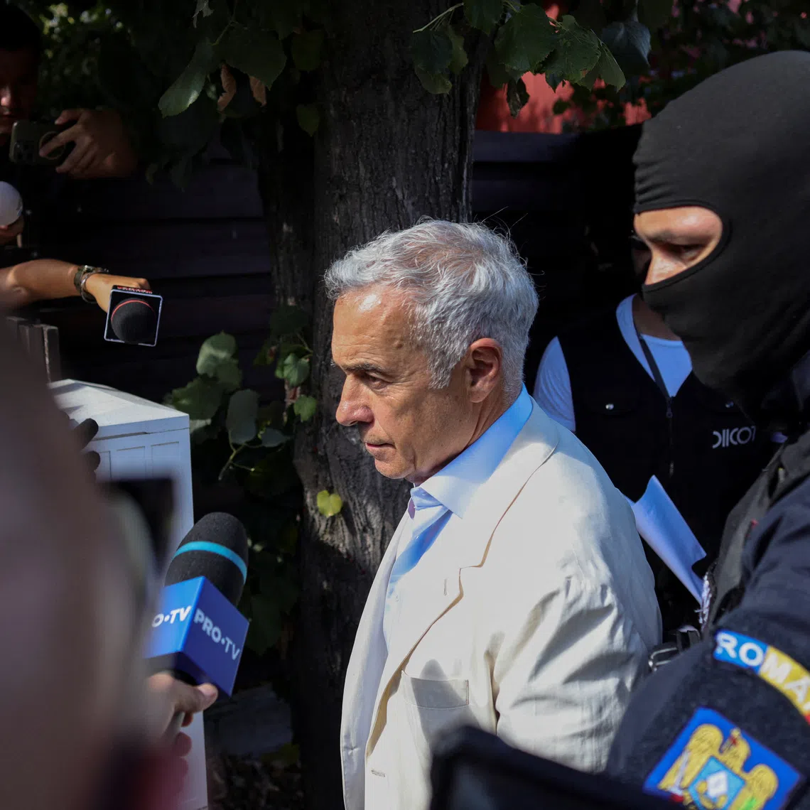 Calin Georgescu, the pro-Russian former frontrunner in the country's 2024 canceled presidential election is escorted by police and gendarmerie officers, in Mogosoaia, Romania, September 21, 2026. Inquam Photos/Octav Ganea via REUTERS