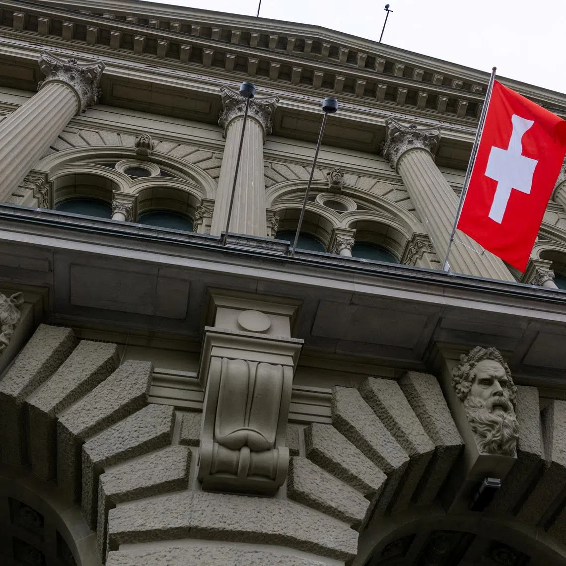 FILE PHOTO: A Swiss flag hangs at the Swiss Parliament building (Bundeshaus) in Bern, Switzerland, March 12, 2025. REUTERS/Denis Balibouse/File Photo
