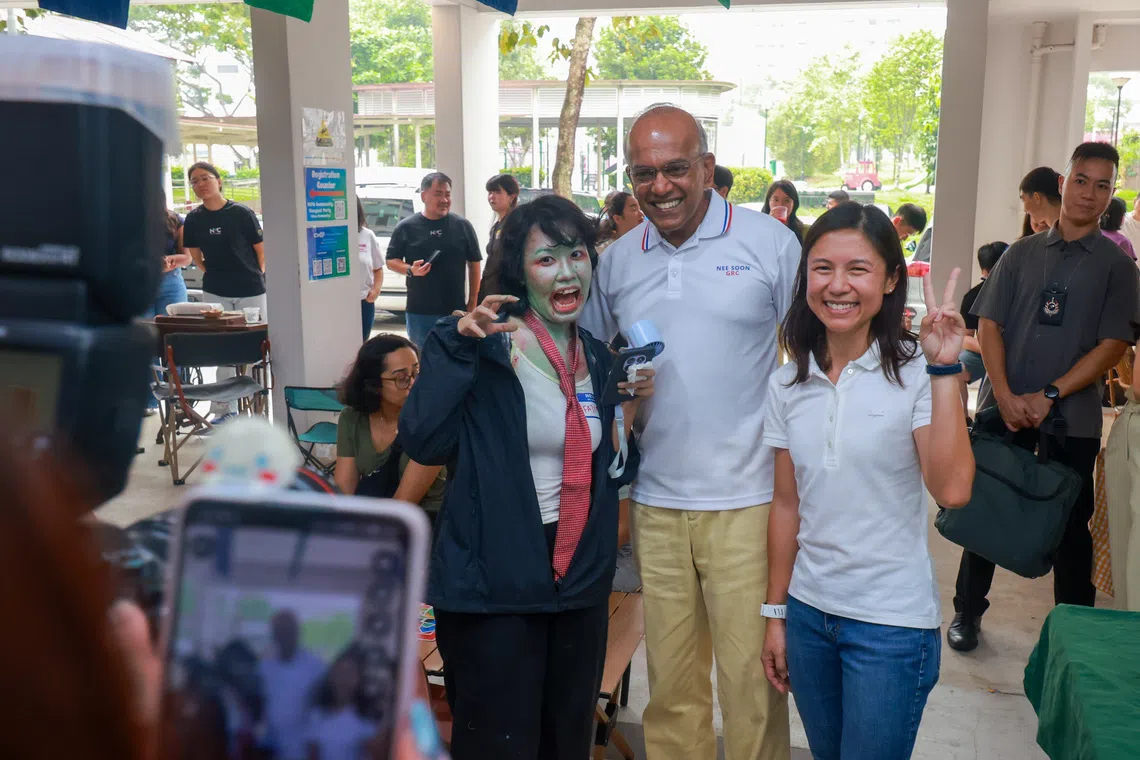 Senior Minister K Shanmugam and SPS Goh Hanyan with Fatimah Azzahraa Alias during a void deck party at the unveiling of The Chop Community.