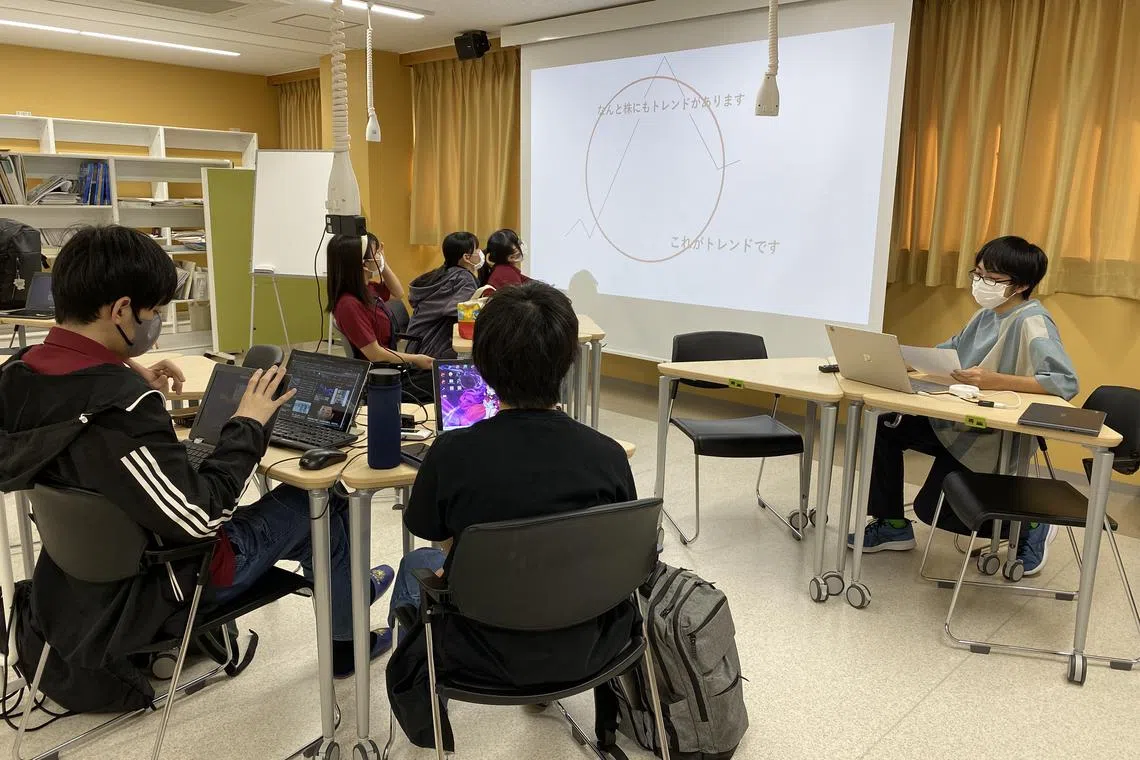 Members of Sendai Ikuei Gakuen Okinawa High School gather once a week to discuss the global economy, as well as the fluctuation of their real-life stock portfolio.