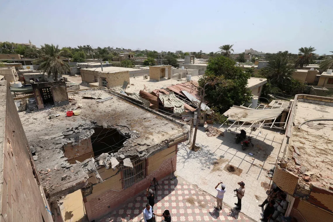 People and journalists gather near damaged buildings following a US strike earlier in the week on Kuhestak, Sirik County, in Iran's southern Hormozgan province on September 6, 2026. A deadly US strike hit a wedding celebration on the night of September 2, 2026, in the coastal town of Kuhestak along Strait of Hormuz in southern Iran, with the Iranian authorities saying it killed at least four people, including a child, and wounded 68 others attending the wedding. The United States announced attacks against targets belonging to Iran's Revolutionary Guards. Iran has been at war since February 28, when the United States and Israel launched a surprise bombing campaign that killed its supreme leader. (Photo by ATTA KENARE / AFP) /