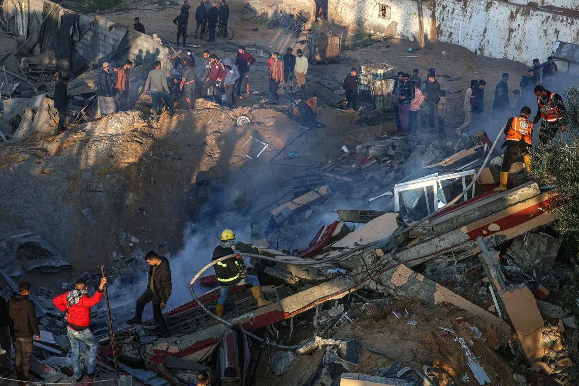 Members of the Palestinian civil defence extinguishing a fire in a building following Israeli bombardments east of Rafah, in the southern Gaza Strip, on Feb 19, 2024.