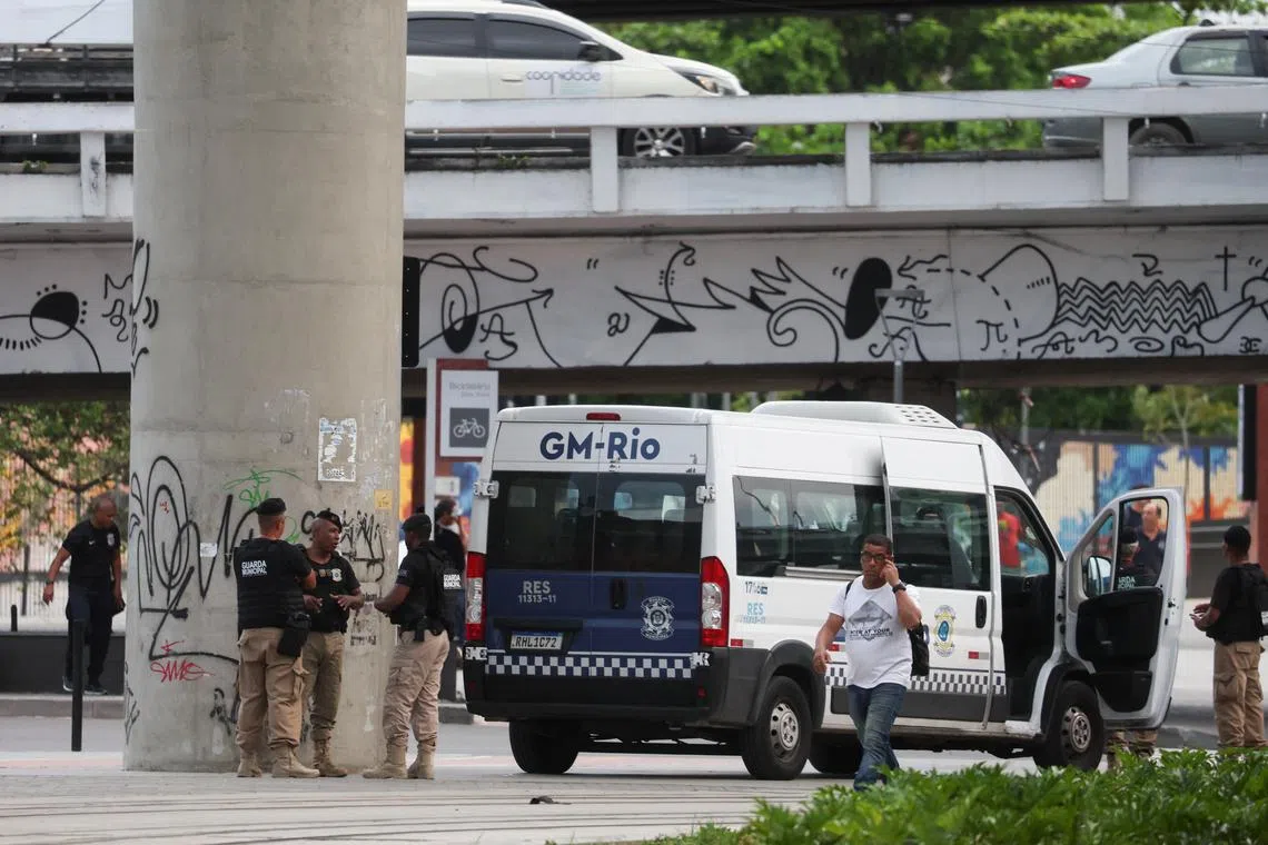 Municipal guards gather near the bus terminal station after a man hijacked a bus with passengers, in Rio de Janeiro, Brazil, March 12, 2024. REUTERS/Pilar Olivares