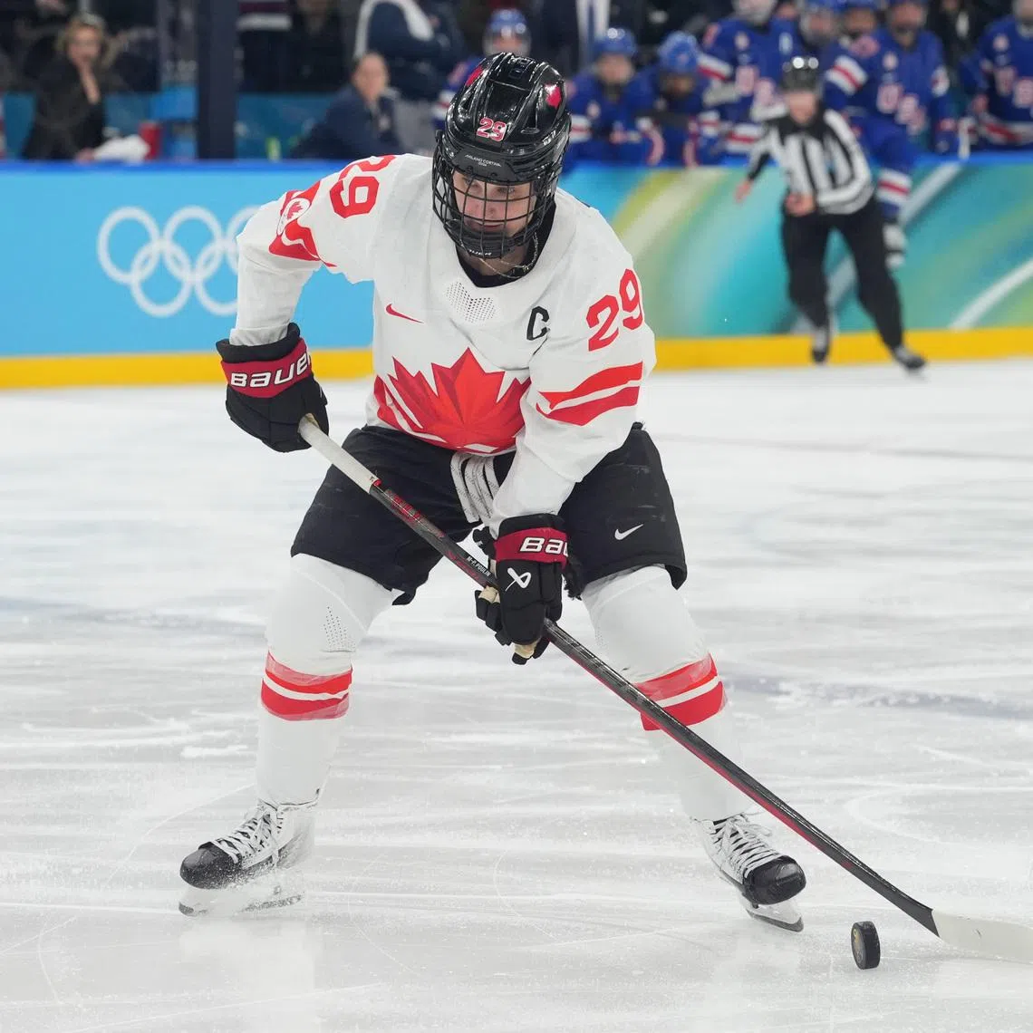 Feb 19, 2026; Milan, Italy; Marie-Philip Poulin (29) of Canada control the puck against the United States in the women's ice hockey gold medal game during the Milano Cortina 2026 Olympic Winter Games at Milano Santagiulia Ice Hockey Arena. Mandatory Credit: Amber Searls-Imagn Images