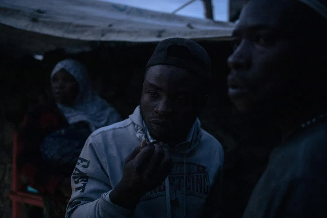 Displaced Muslims wait to break the Ramadan fast at nightfall at an informal displacement camp in Goma, eastern Democratic Republic of Congo, March 27.