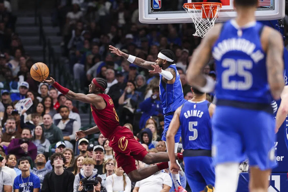Cleveland Cavaliers guard Caris LeVert makes a circus shot over Dallas Mavericks guard Jaden Hardy during the second half at American Airlines Centre.