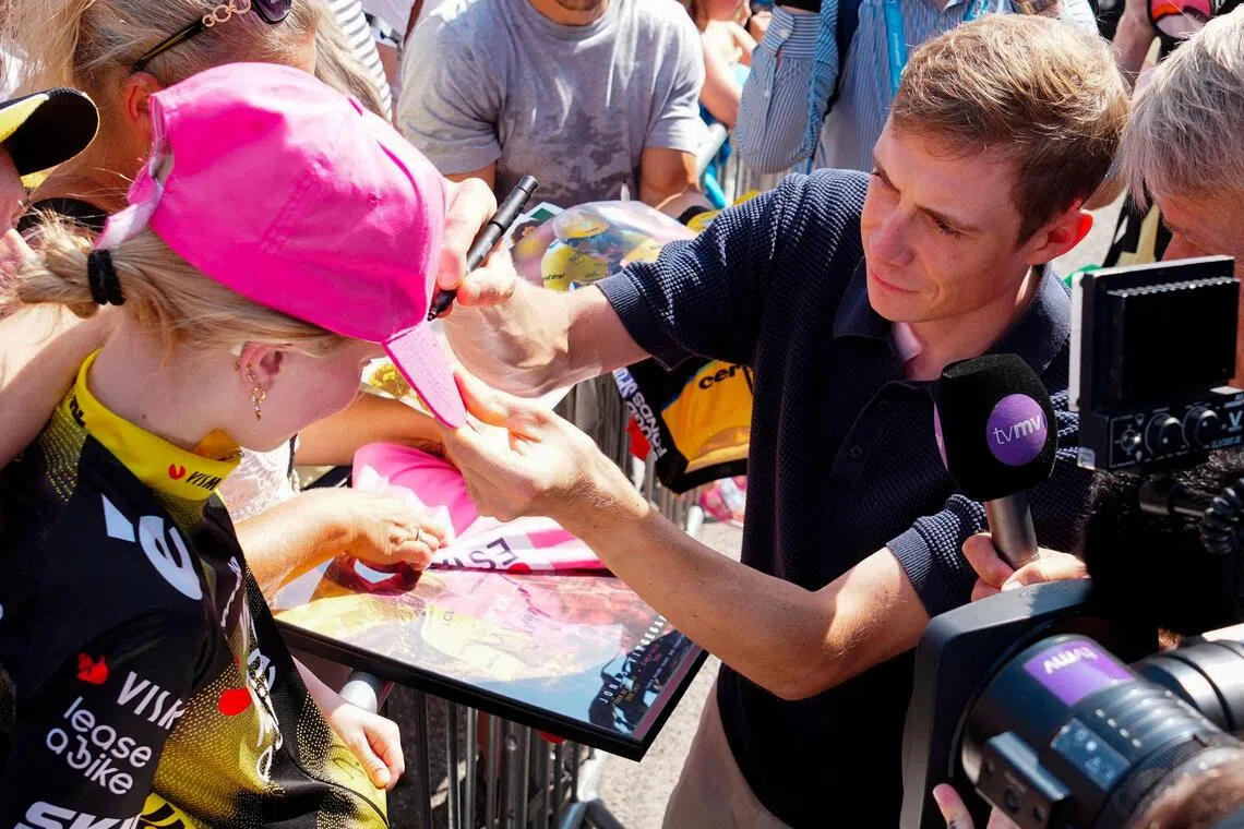 Danish cyclist Jonas Vingegaard signs autographs for fans in Glyngoere, Denmark on July 30, during the second stage of the PostNord Denmark Tour.