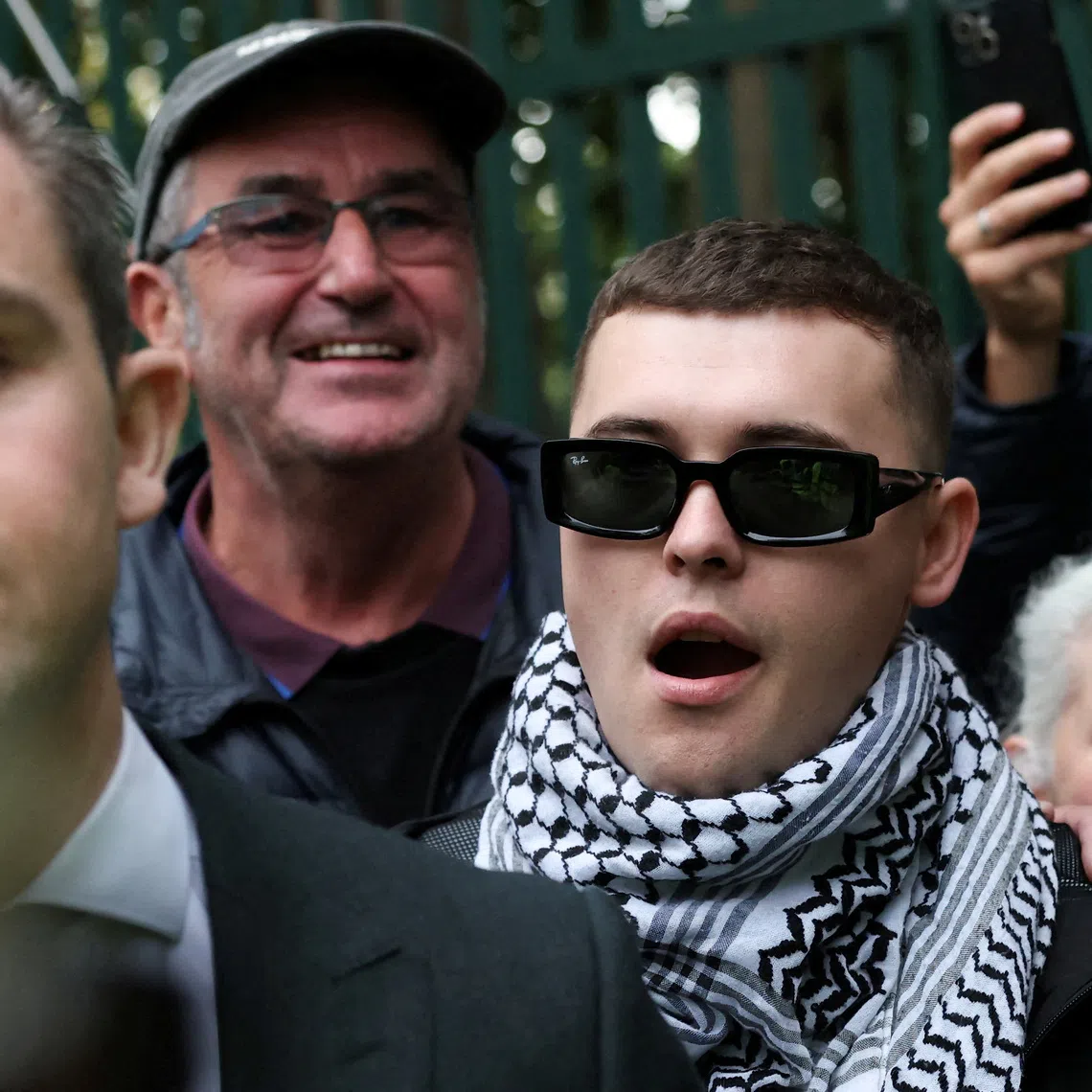 Member of Kneecap Liam O'Hanna, also known as Liam Og O hAnnaidh and performing under the name of Mo Chara, walks outside Woolwich Crown Court, after a UK court threw out his prosecution for a terrorism offence, in London, Britain, Friday September 26, 2025. REUTERS/Hannah McKay     TPX IMAGES OF THE DAY
