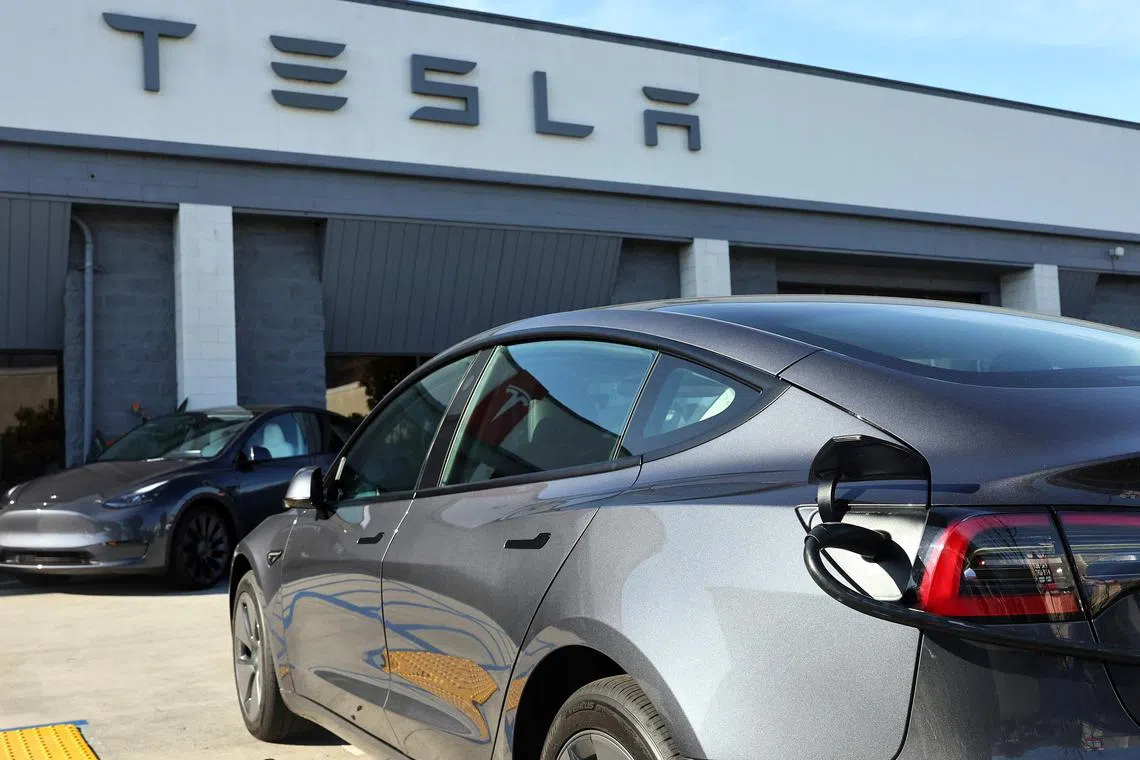 BURBANK, CALIFORNIA - JANUARY 16: A Tesla electric car recharges at a Tesla dealership on January 16, 2024 in Burbank, California. Carbon emissions fell by about 1.9 percent in 2023, a positive signal, but further cuts must be implemented if the U.S. hopes to achieve its climate goal of 50 percent emissions cuts by 2030. Mario Tama/Getty Images/AFP (Photo by MARIO TAMA / GETTY IMAGES NORTH AMERICA / Getty Images via AFP)