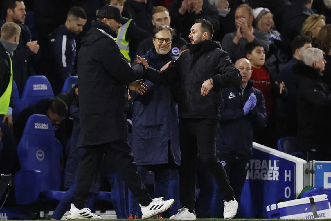 FILE PHOTO: Soccer Football - Premier League - Brighton &amp; Hove Albion v Liverpool - The American Express Community Stadium, Brighton, Britain - January 14, 2023 Liverpool manager Juergen Klopp shakes hands with Brighton &amp; Hove Albion manager Roberto De Zerbi after the match Action Images via Reuters/Andrew Couldridge/File Photo