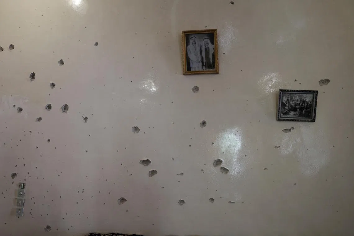 FILE PHOTO: A wall is pockmarked by bullet holes inside the Saraya family house, following sectarian violence in Syria's Sweida province, where government forces were sent to quell local clashes between Druze armed factions and Bedouin tribal fighters, in the predominantly Druze city of Sweida, Syria, July 25, 2025. REUTERS/Khalil Ashawi/File Photo
