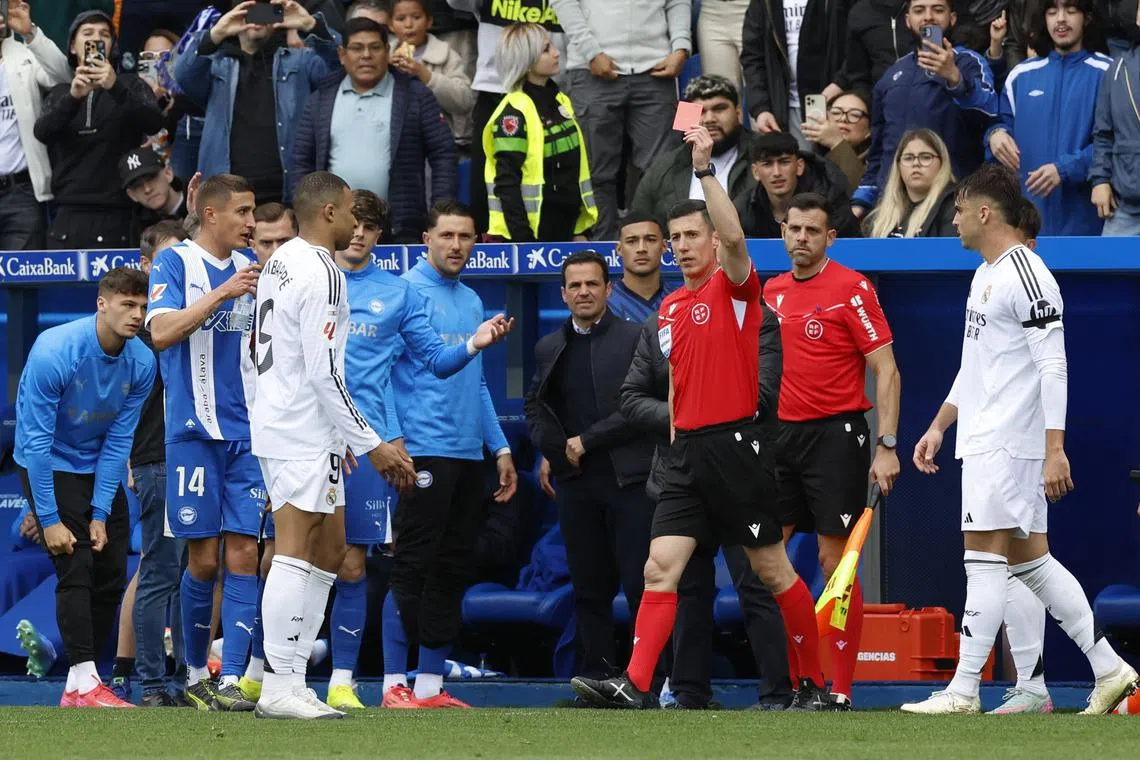 Soccer Football - LaLiga - Deportivo Alaves v Real Madrid - Estadio Mendizorroza, Vitoria-Gasteiz, Spain - April 13, 2025 Real Madrid's Kylian Mbappe is shown a red card by referee Cesar Soto Grado REUTERS/Vincent West