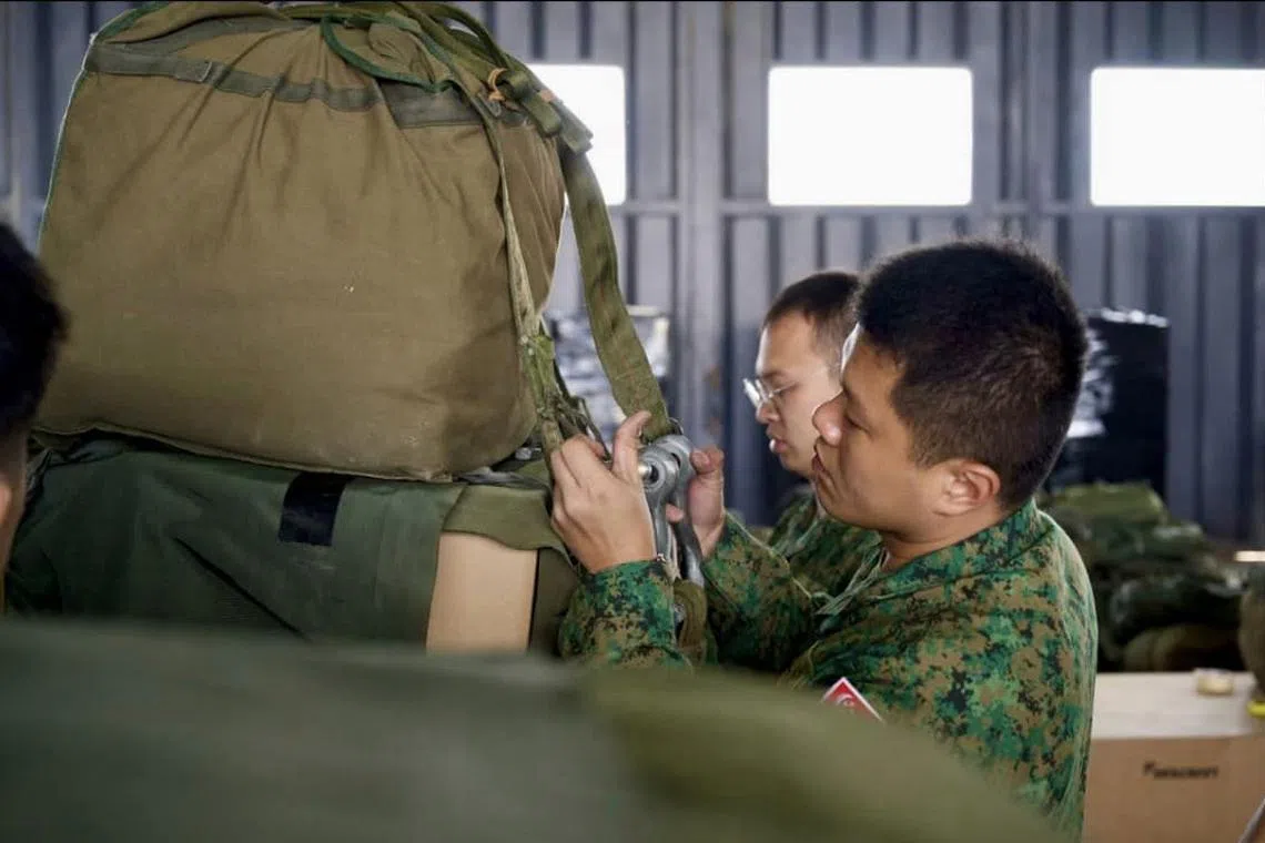 After the humanitarian supplies are secured, parachutes are attached.