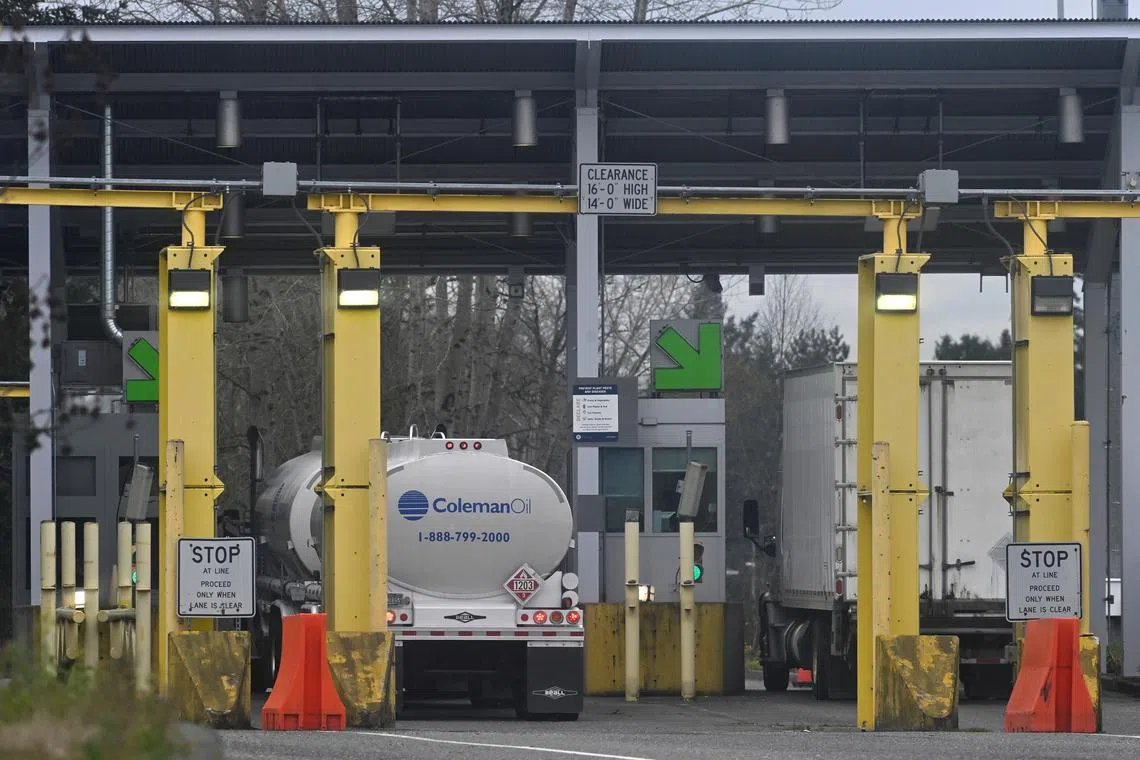 Commercial trucks head towards the U.S. Customs and Border Protection (CBP) Pacific Highway Port of Entry from south Surrey, British Columbia, Canada, November 26, 2024.  REUTERS/Jennifer Gauthier/File Photo