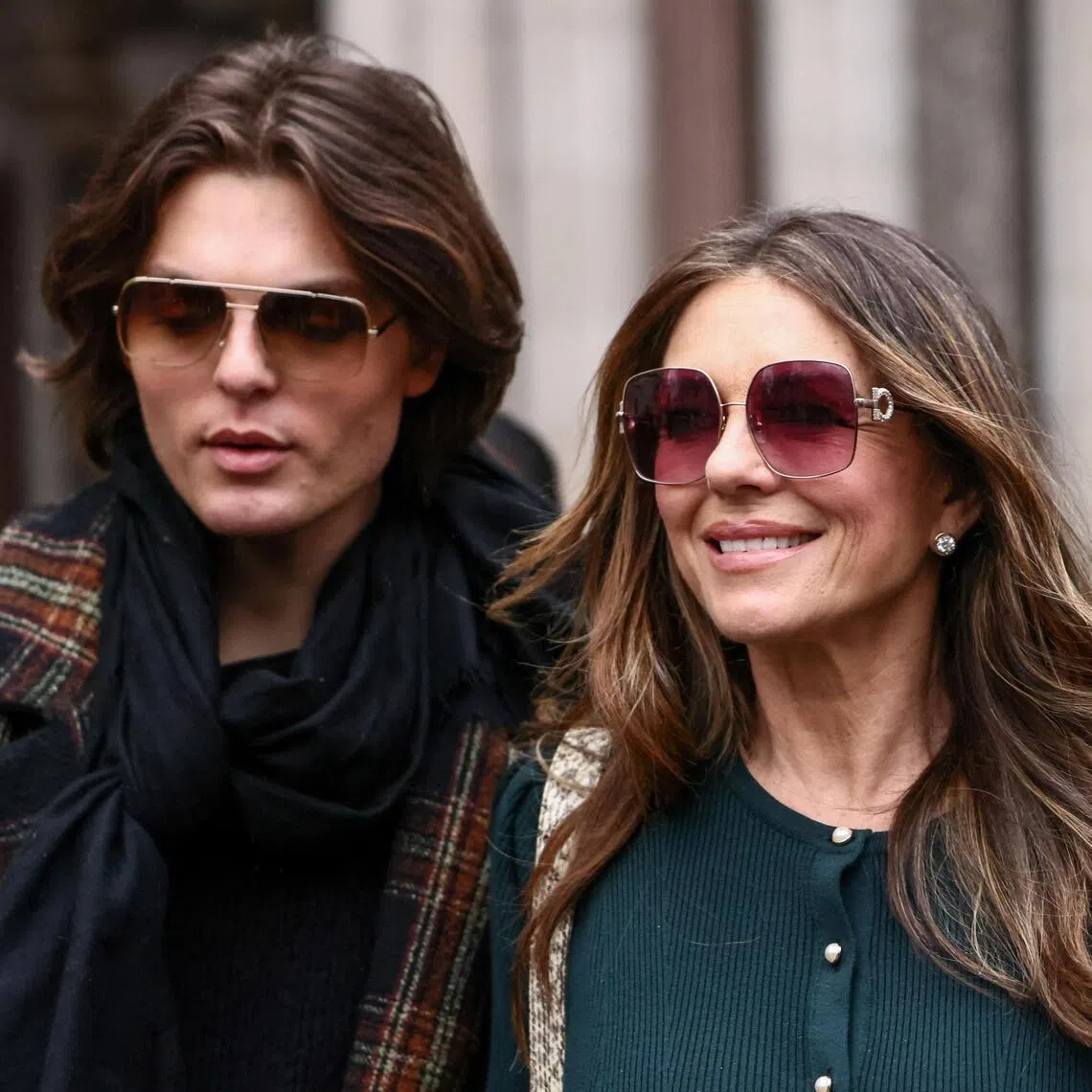 Actress Elizabeth Hurley and her son, Damian Hurley, outside the High Court in London on Jan 22, during the first week of a nine-week lawsuit against Associated Newspapers, publisher of the Daily Mail.