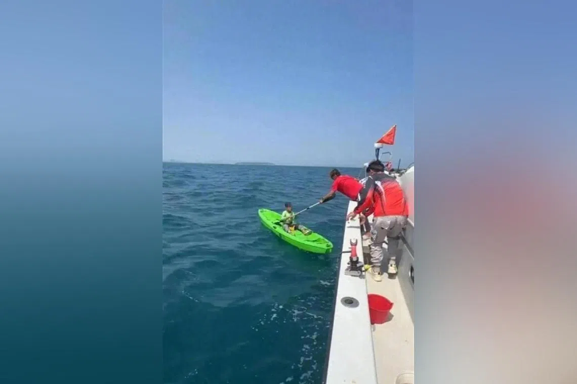 The boy being rescued by a group of men fishing near Sanya, some 9 nautical miles from where the boy was first fishing.
