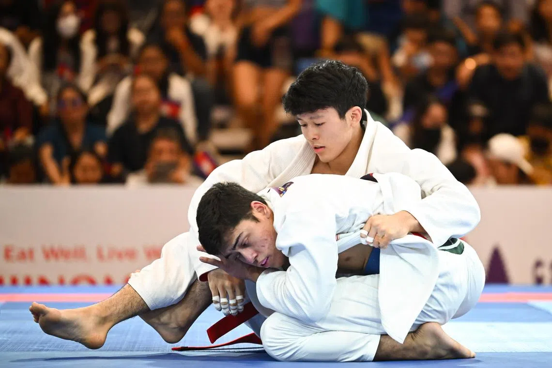 Noah Lim (top) won Singapore's first gold medal at the Cambodia SEA Games in the men's ne-waza gi under-69kg on Saturday. 
