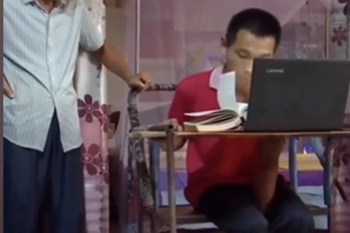 Zhang Jiubin grew up without full control of his hands and speech abilities.