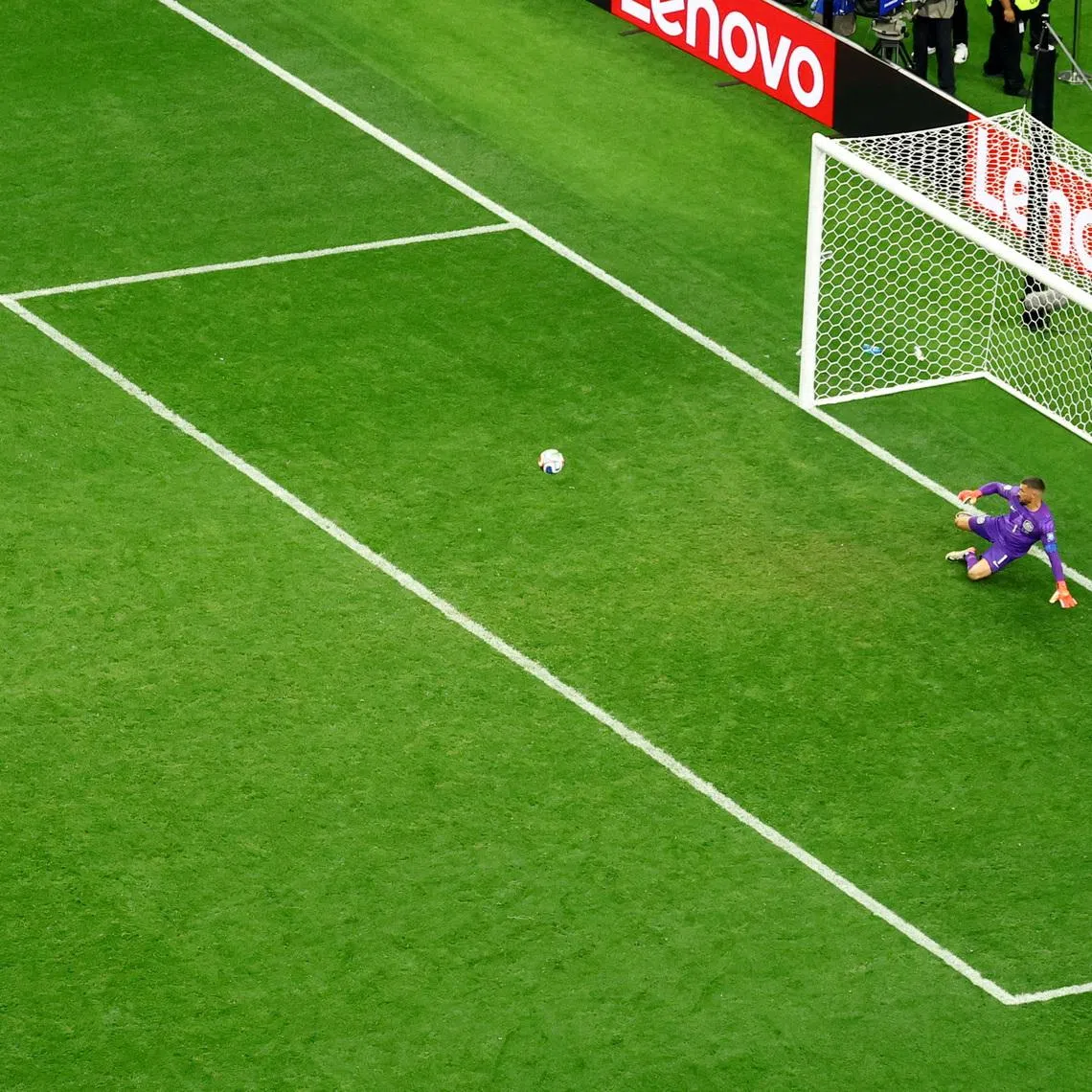 Egypt’s Hossam Abdelmaguid scores the deciding penalty against Australia’s Mathew Ryan during the penalty shoot-out to win the match as Egypt.