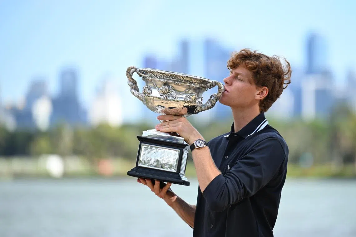 Jannik Sinner of Italy posing with his trophy after winning the Australian Open men’s singles title in Melbourne, Australia, on Jan 27. Sinner is celebrating his second consecutive Australian Open men’s singles title.  EPA-EFE/JAMES ROSS AUSTRALIA AND NEW ZEALAND OUT