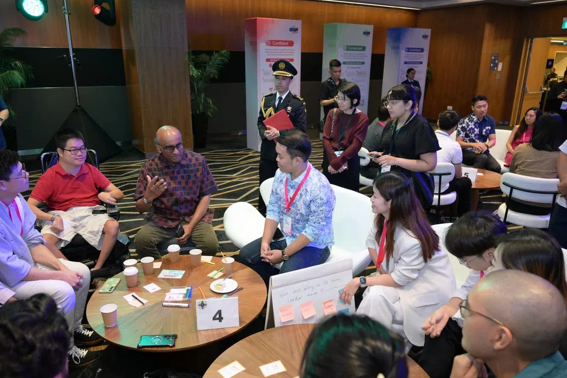 President Tharman Shanmugaratnam (third from left) speaking to youth leaders at a closed door networking session on July 25.