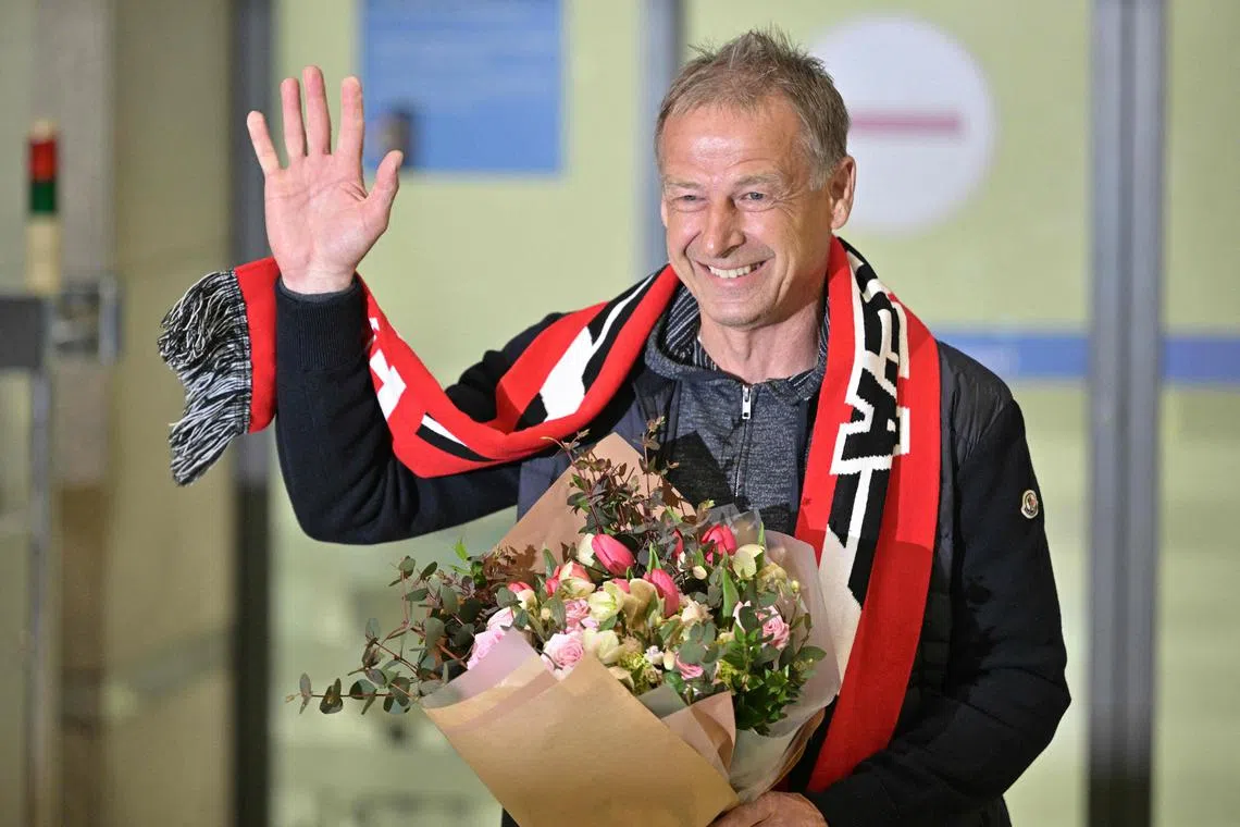Jurgen Klinsmann, newly appointed manager of South Korea’s national football team, waving as he arrives at the Incheon International Airport, on Wednesday.