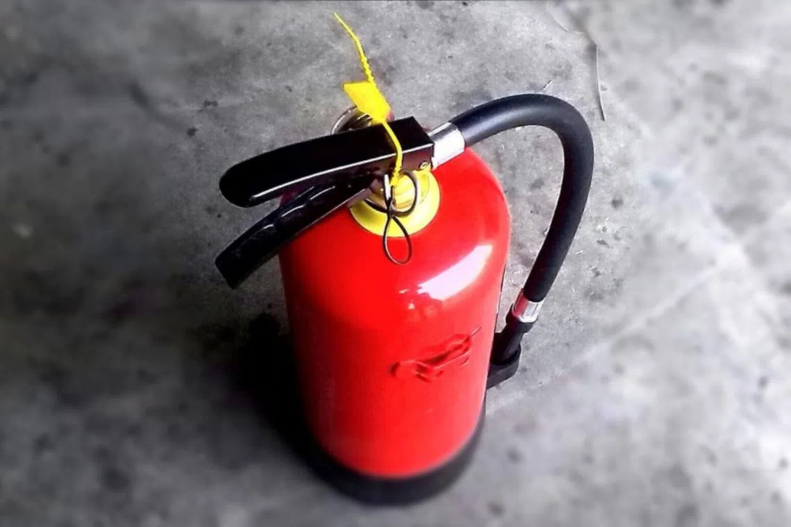 A file photo of a fire extinguisher. Victims were told that it is compulsory for every HDB flat to own the device, among other lies.