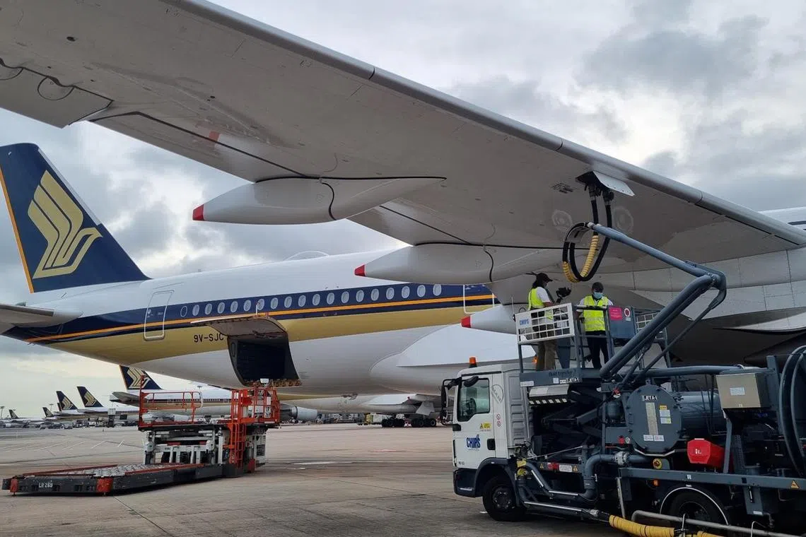 A Singapore Airlines plane being refuelled with blended sustainable aviation fuel at Changi Airport.