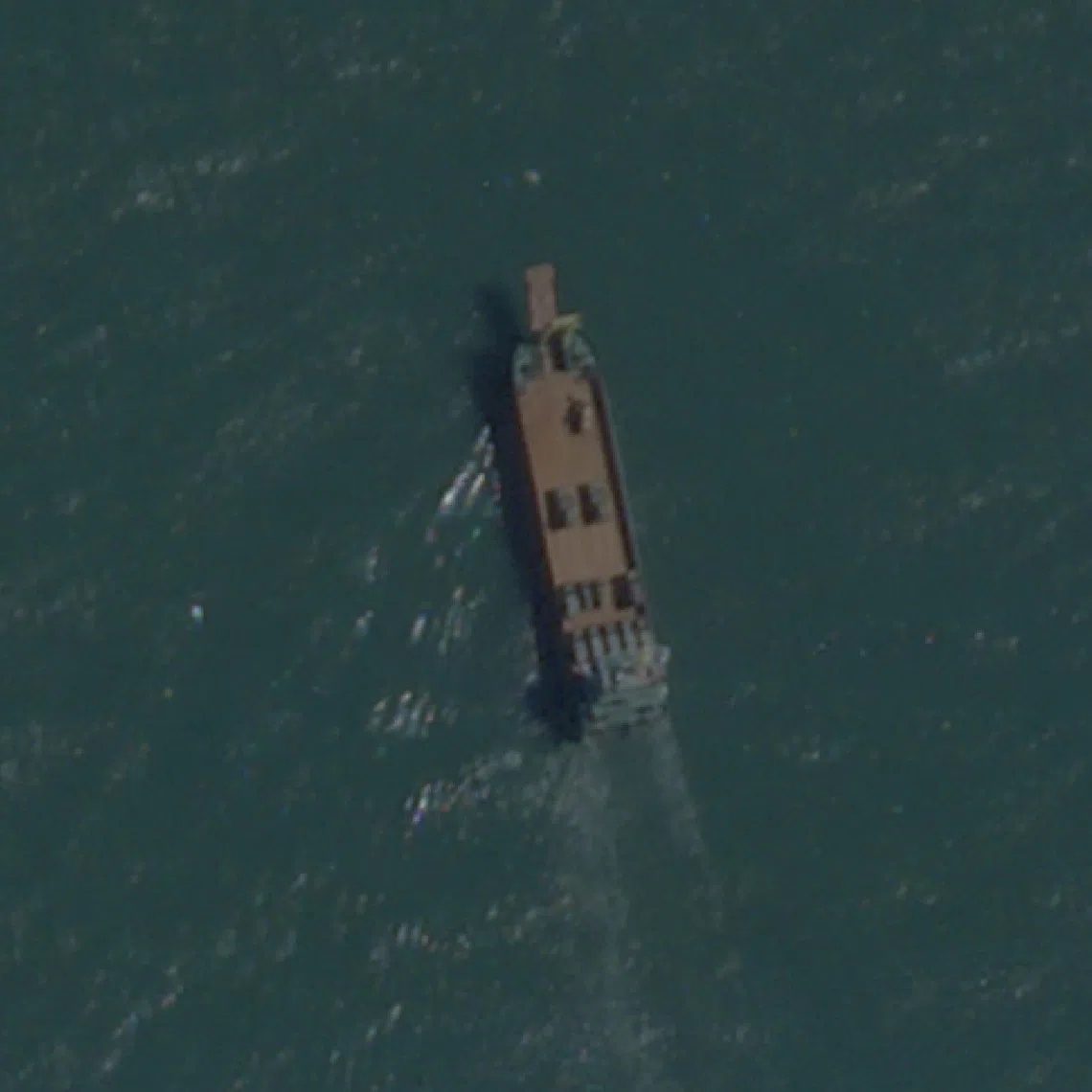 FILE PHOTO: A satellite image taken by Planet Labs shows a deck cargo ship, loaded with vehicles, cruising towards the beach near Jiesheng, Guangdong, China July 16, 2025. Planet Labs PBC/Handout via REUTERS/File Photo