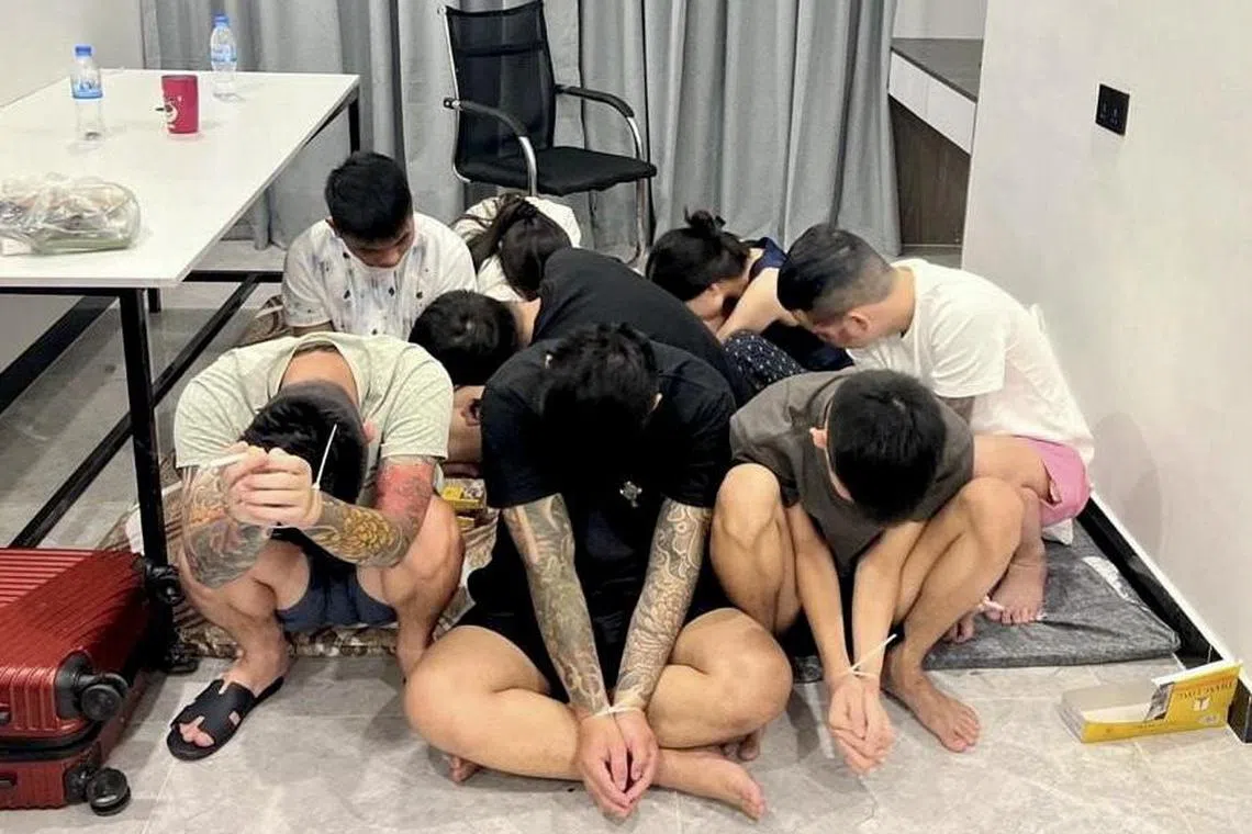epa12241013 Suspects are seen with their hands zip-tied after being detained during a police raid on a scam center in Phnom Penh, Cambodia, 16 July 2025. The operation was part of a nationwide crackdown on cybercrime networks, following Prime Minister Hun Manet’s order to shut down online scam operations often run like sweatshops.  EPA/TRA / AKP / POOL