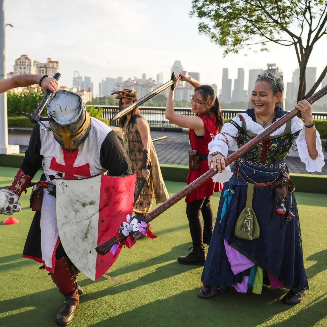 Members of LARP Singapore Community role-playing in their costumes at the Lawn Bowl in Singapore Sports Hub on Aug 16, 2025.