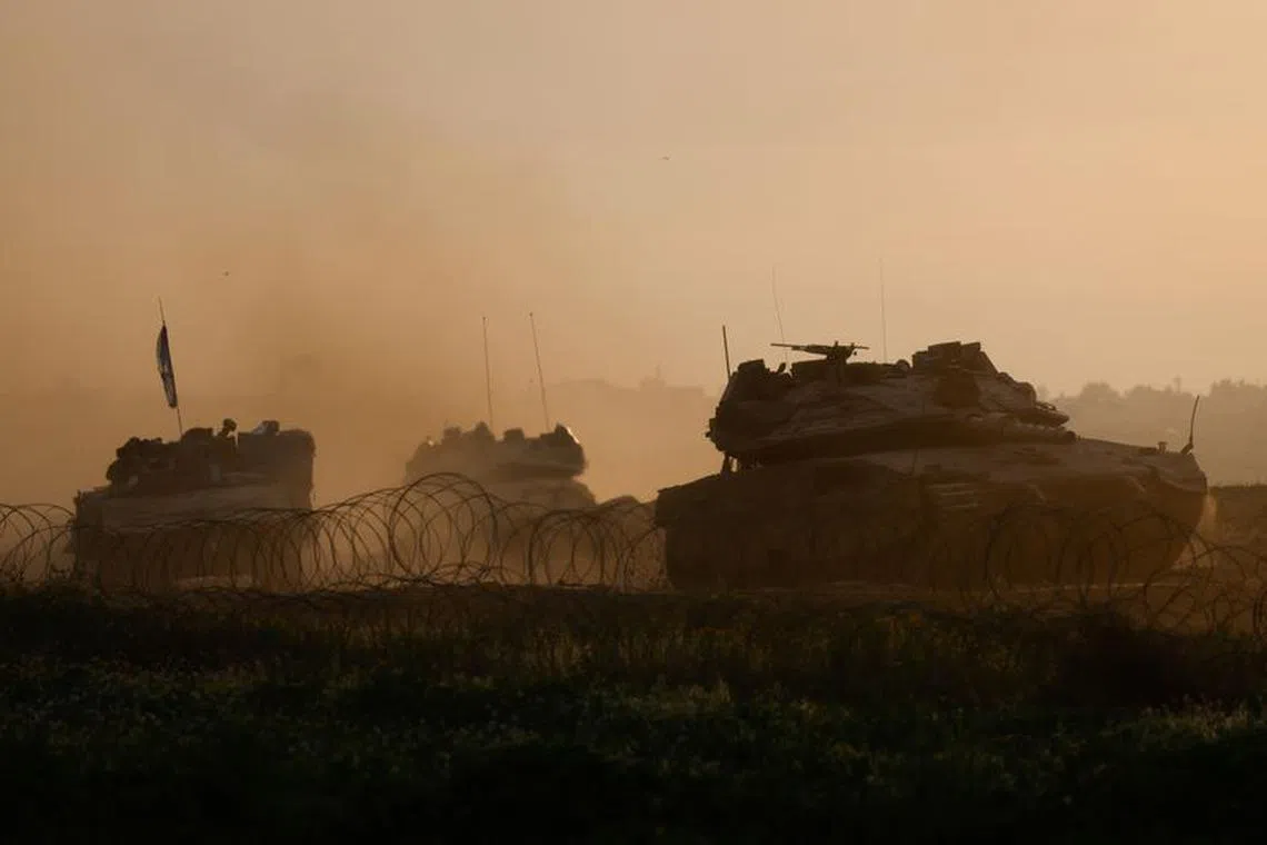 Israeli military vehicles manoeuvre on the border with southern Gaza, amid the ongoing conflict between Israel and the Palestinian Islamist group Hamas, as seen from Israel, February 12, 2024. REUTERS/Amir Cohen