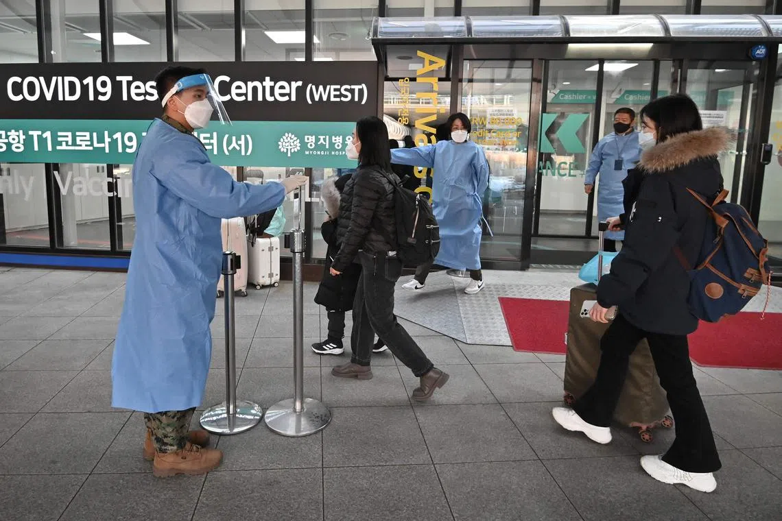 Travellers arriving from China entering a Covid-19 testing centre at South Korea's Incheon International Airport on Jan 3.