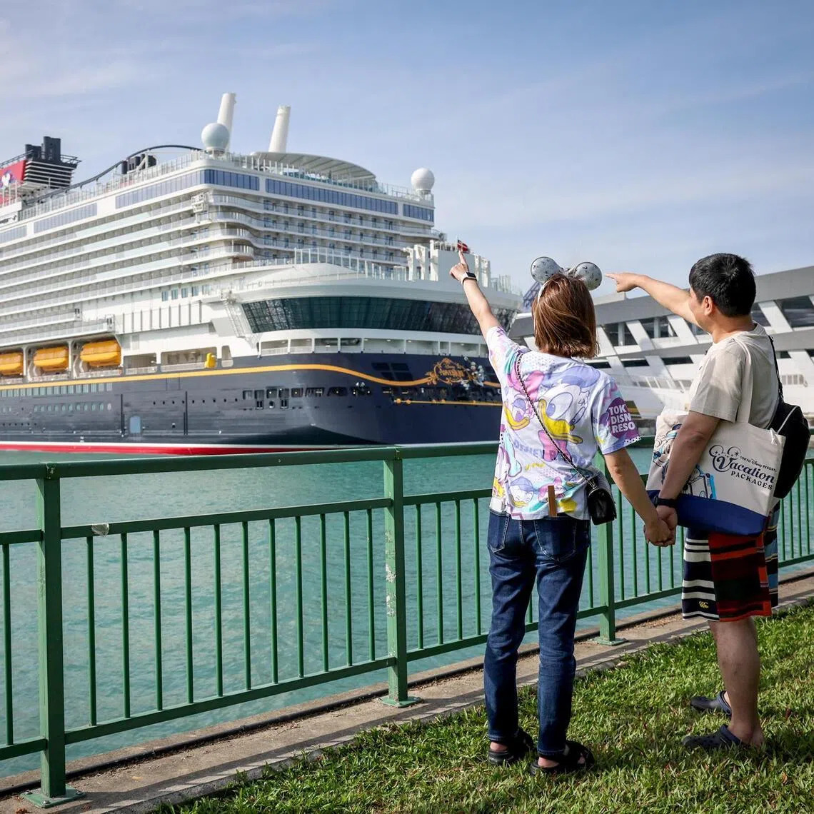 Two passengers pose for a photograph ahead of the Disney Adventure’s maiden voyage on March 10. The cruise will roll out a US$5 (S$6.40) delivery charge for in-room dining orders from June 4.