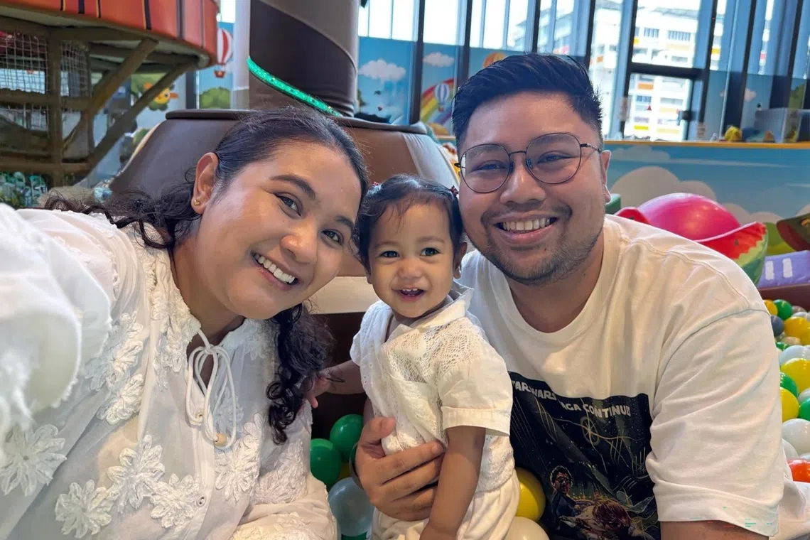 Community manager Shahrin Iskandar (right) with his wife and daughter. The family welcomed the news of upcoming fee reductions for government-supported pre-schools.
