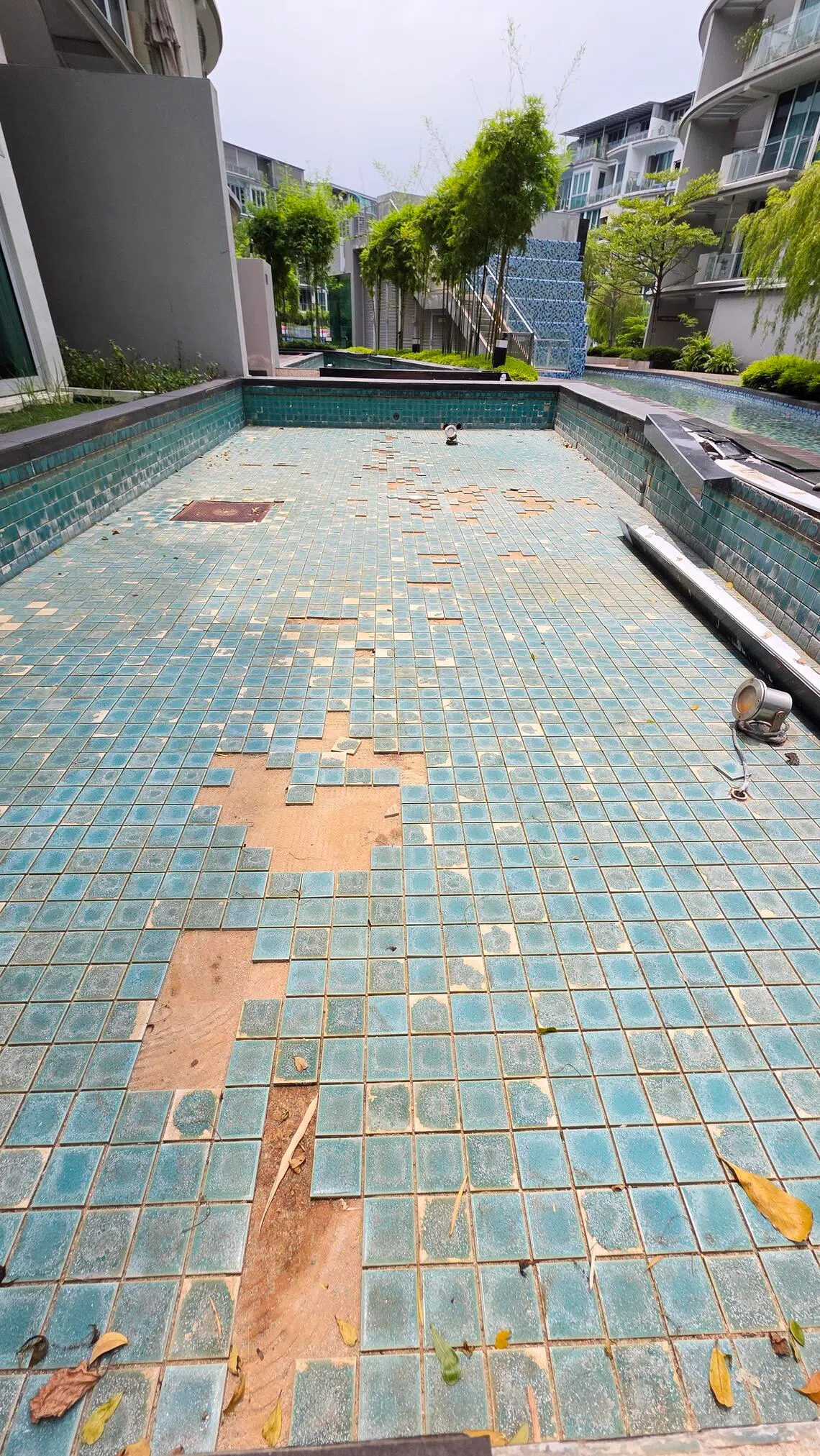 Canberra Residences MCST claimed that missing and or detached tiles to feature ponds have not been replaced.