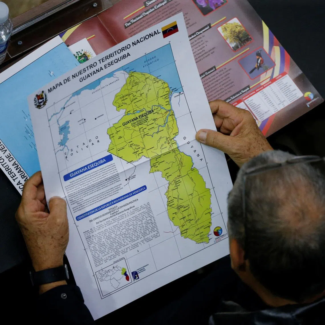FILE PHOTO: A member of the National Assembly of the Assembly holds a map showing the disputed Esequibo region as part of Venezuela, as tensions between the Venezuela and Guyana have ratcheted up in recent weeks over a long-running territorial dispute, in Caracas, Venezuela, December 6, 2023. REUTERS/Leonardo Fernandez Viloria/File Photo