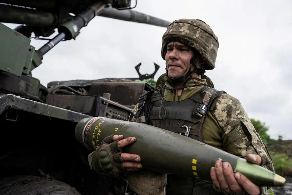 FILE PHOTO: A Ukrainian service member of the 55th Separate Artillery Brigade prepare carries a shell for a Caesar self-propelled howitzer before firing towards Russian troops, amid Russia's attack on Ukraine, near the town of Avdiivka in Donetsk region, Ukraine May 31, 2023. REUTERS/Viacheslav Ratynskyi/File Photo