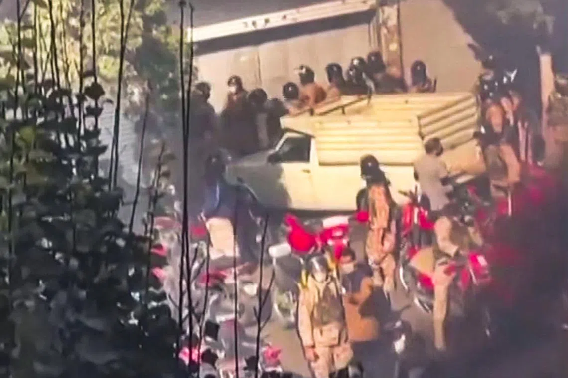 A screengrab from a video posted on social media purportedly shows security forces trying to enter a closed shopping centre in Teheran.