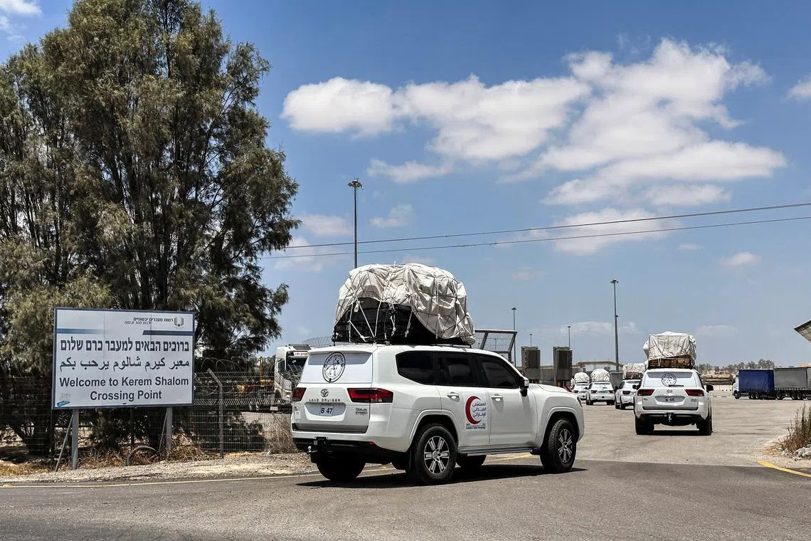 Vehicles, loaded with goods, enter the Kerem Shalom crossing between Israel and Gaza, on the Israeli side, on their way into Gaza May 28, 2025. REUTERS/Shafiek Tassiem